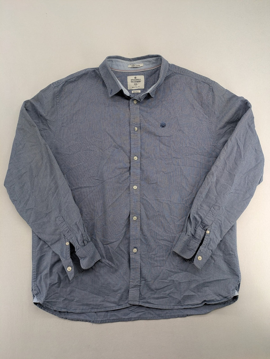 Springfield blue Oxford shirt with button placket and subtle logo embroidery.