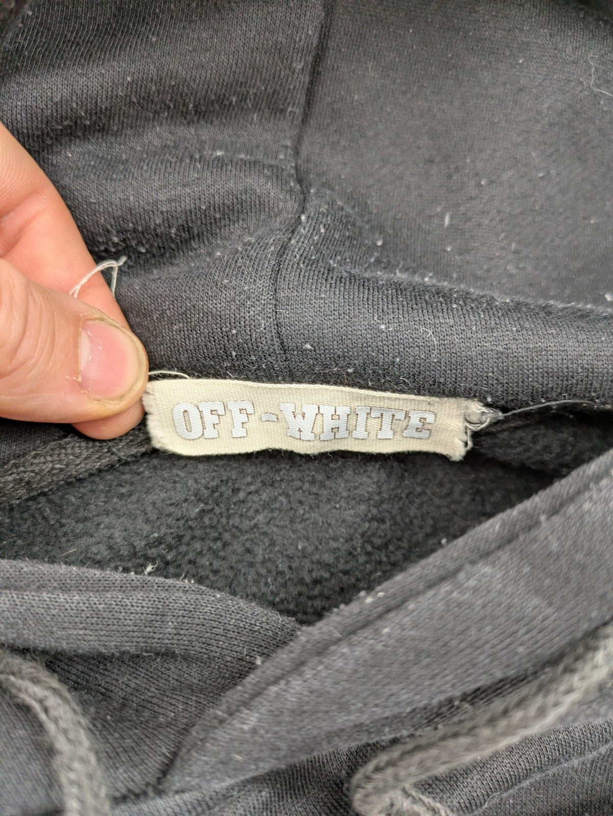 Off-White white zip-through hoodie with diagonal stripes and large arrows graphic.