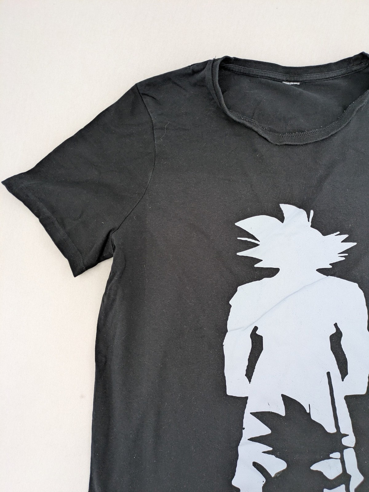 Dragon Ball Z black t-shirt featuring blue Son Goku silhouette graphic design.