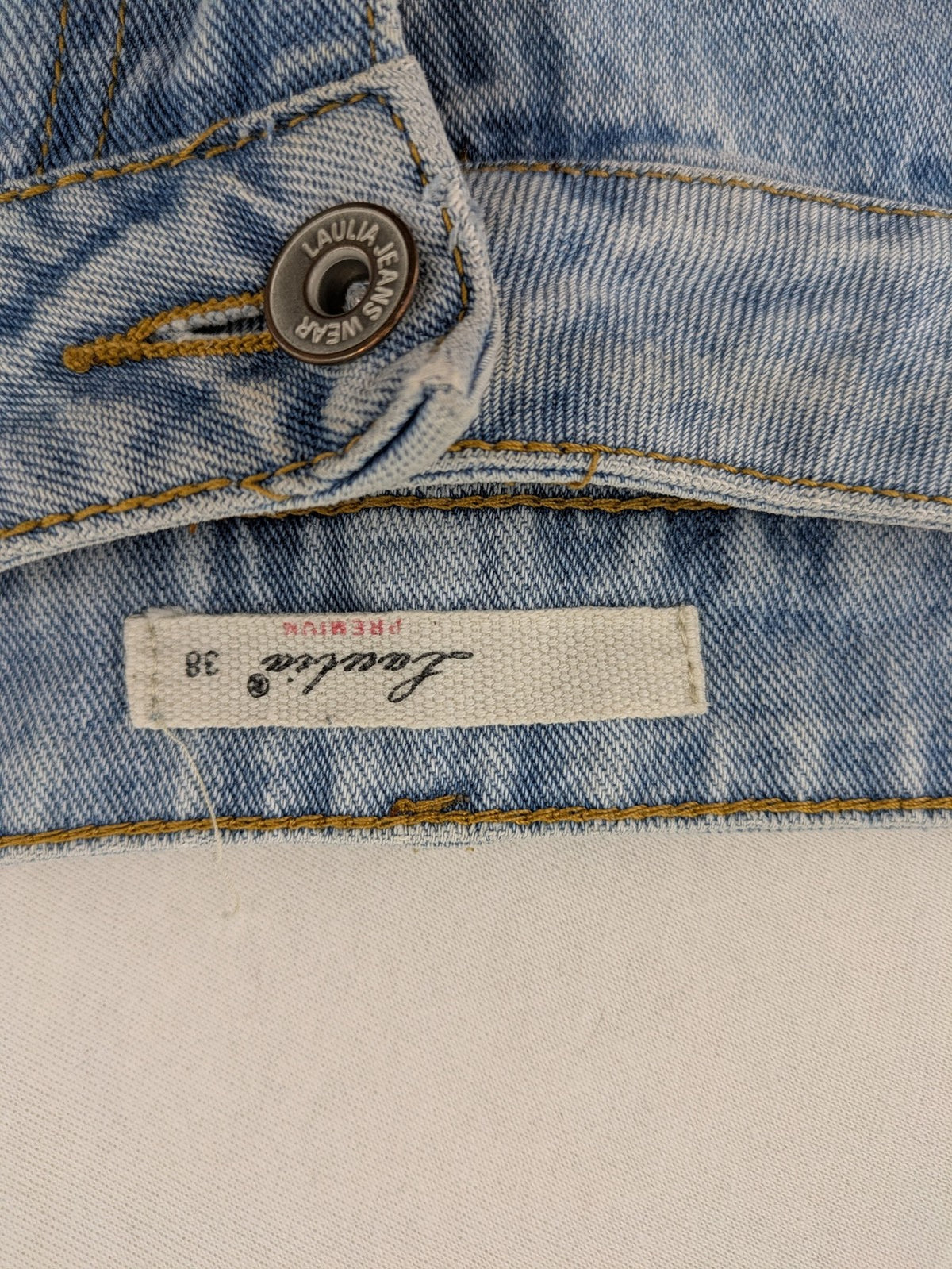 Laulia blue wide leg jeans with distressed knee rips and high waist design.