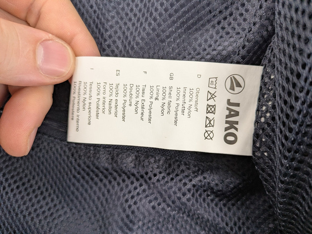 Jako navy windbreaker full zip jacket with breathable mesh lining and logo details.