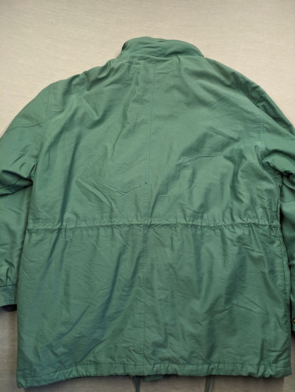 Canda green parka coat with dark lining, multiple pockets, and Micro Membrane technology.