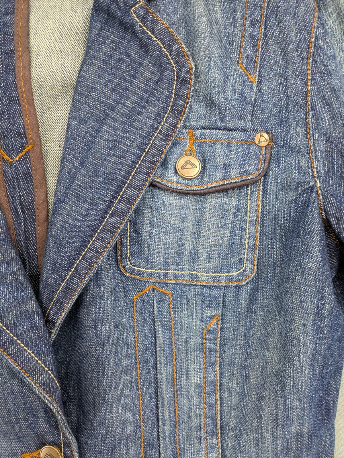 Authentic Clothing Company blue jeans blazer with contrast stitching and button closure.