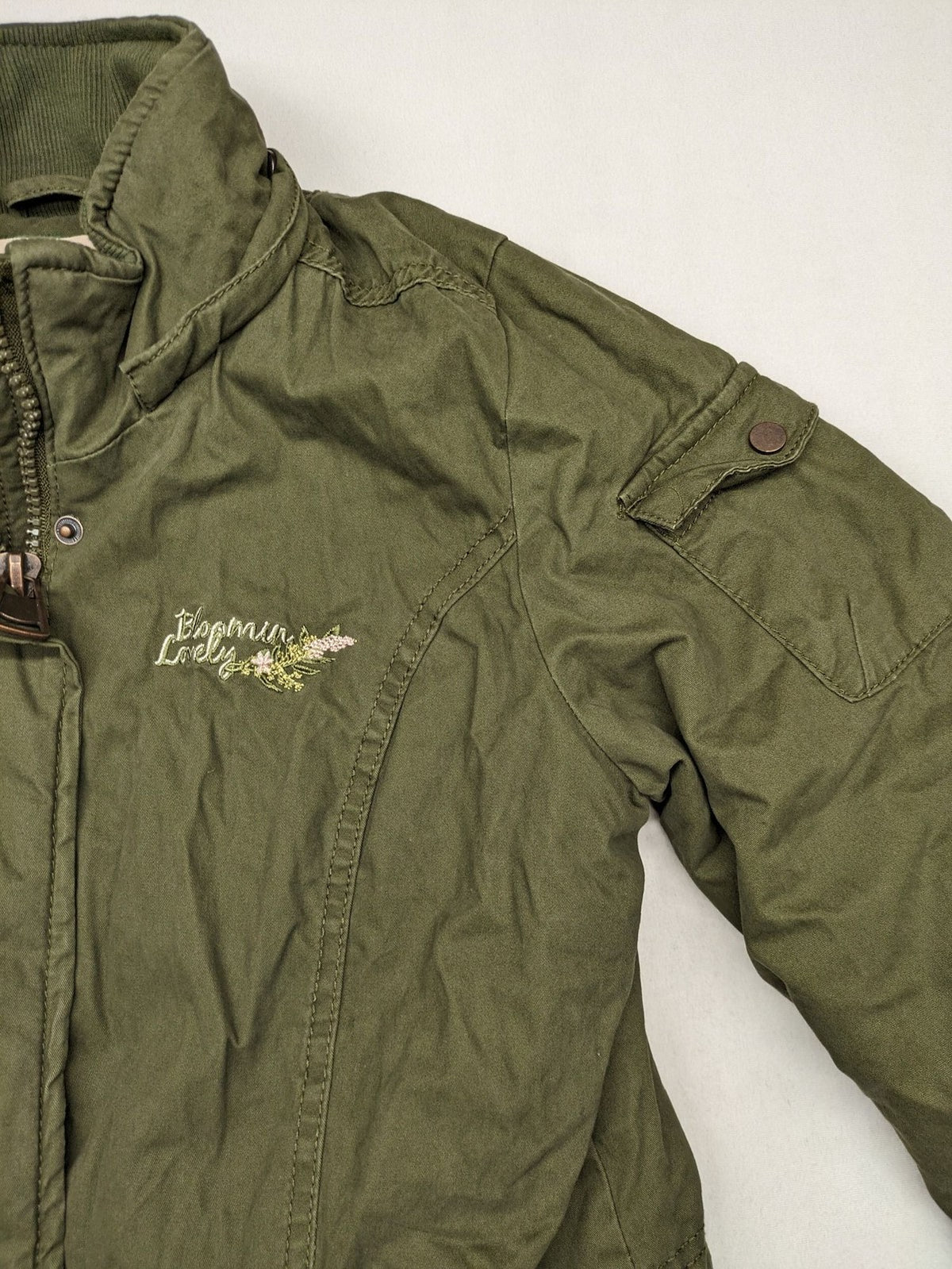 Vp Fashion khaki parka coat with "Bloomin' Lovely" floral embroidery and quilted lining.