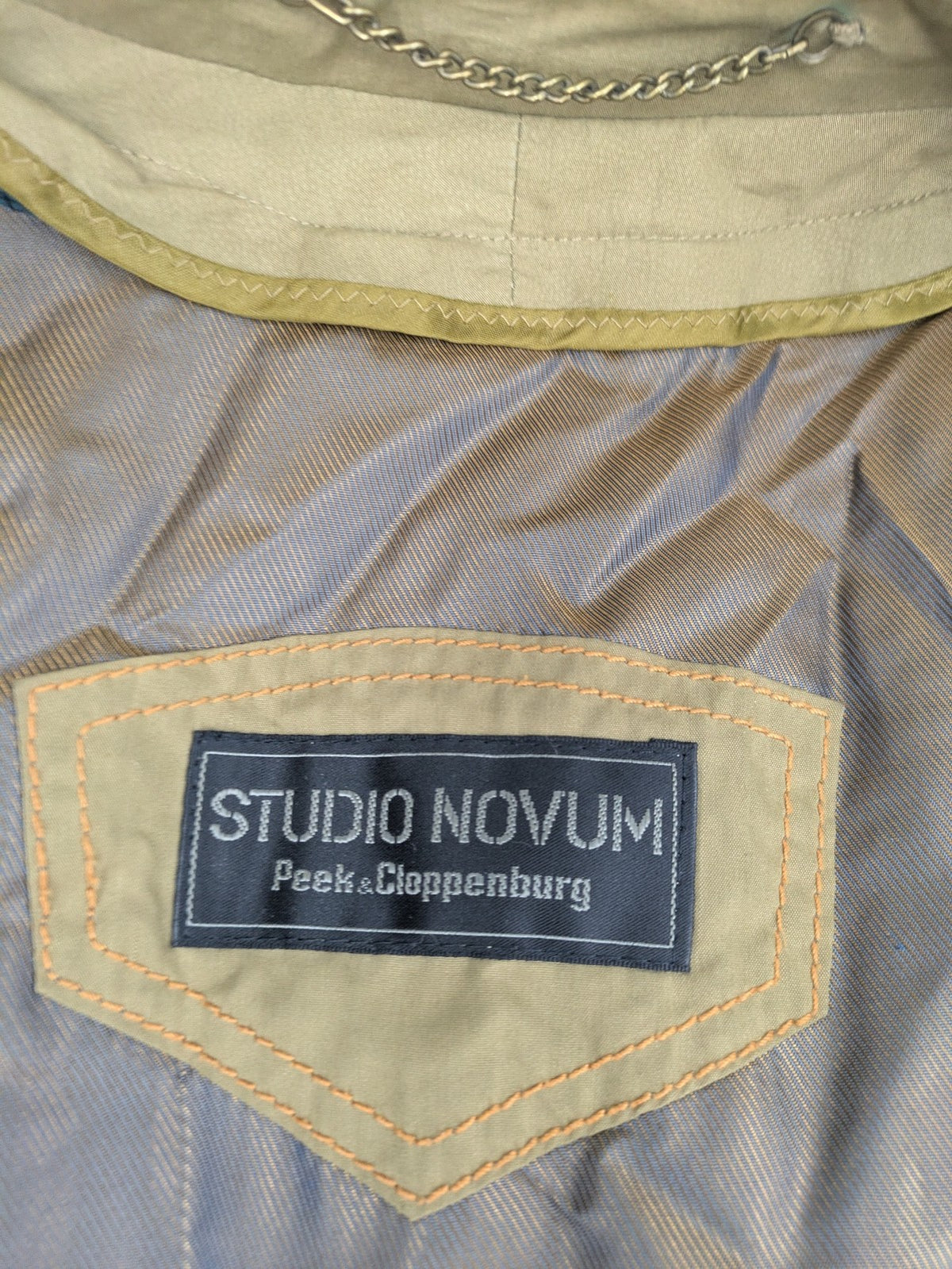 Studio Novum khaki trench coat double-breasted design with belt and wool lining.