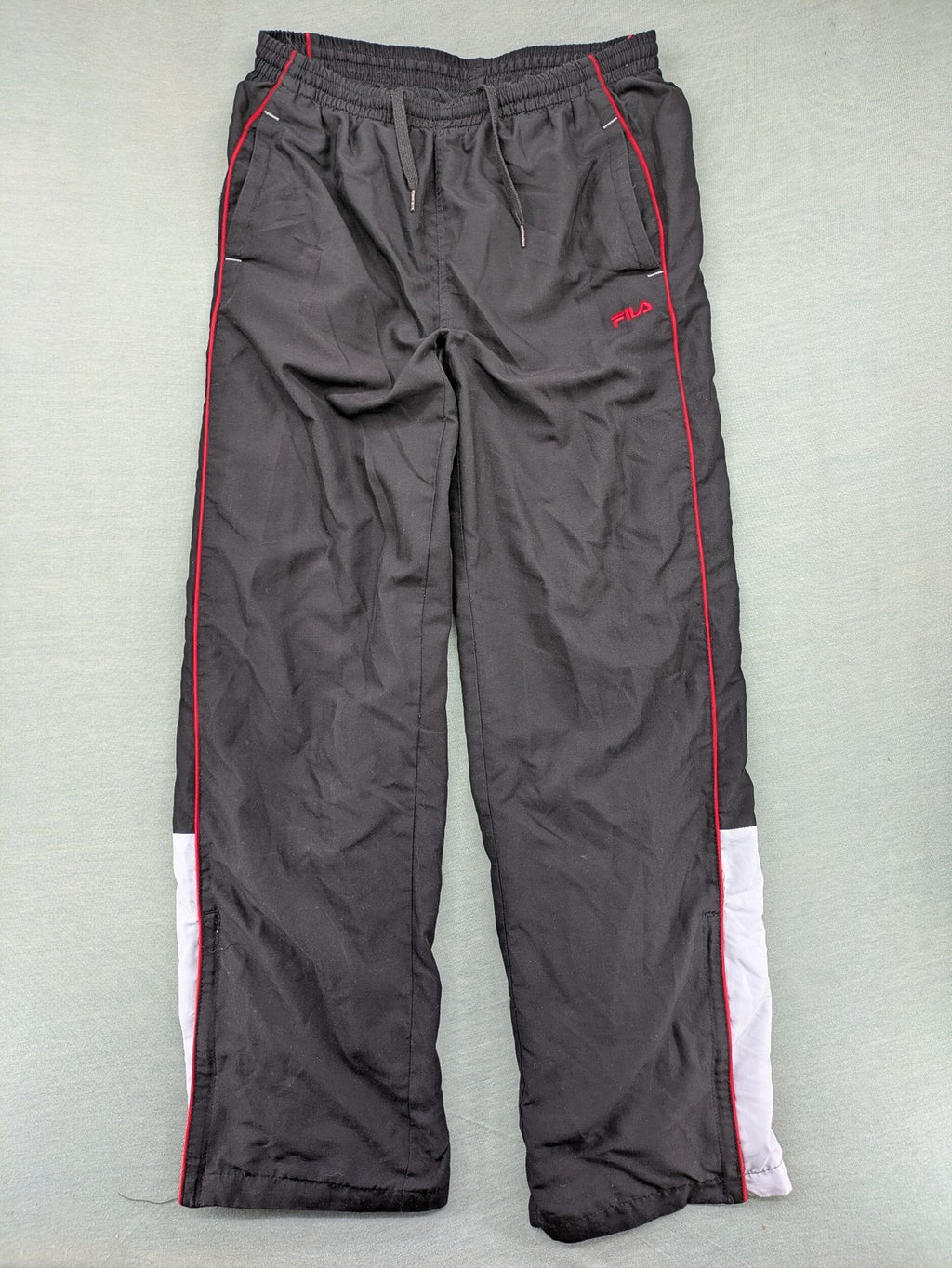 Fila grey jogging pants with red piping and embroidered logo on thigh.