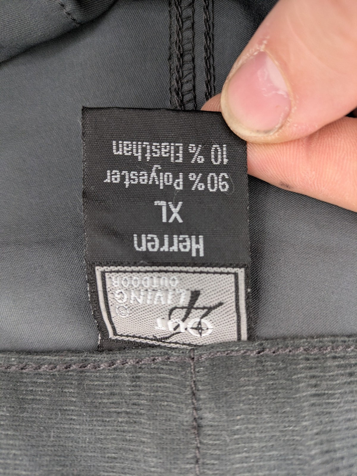 Outdoor grey functional shorts with adjustable velcro waistband and zippered leg pocket.