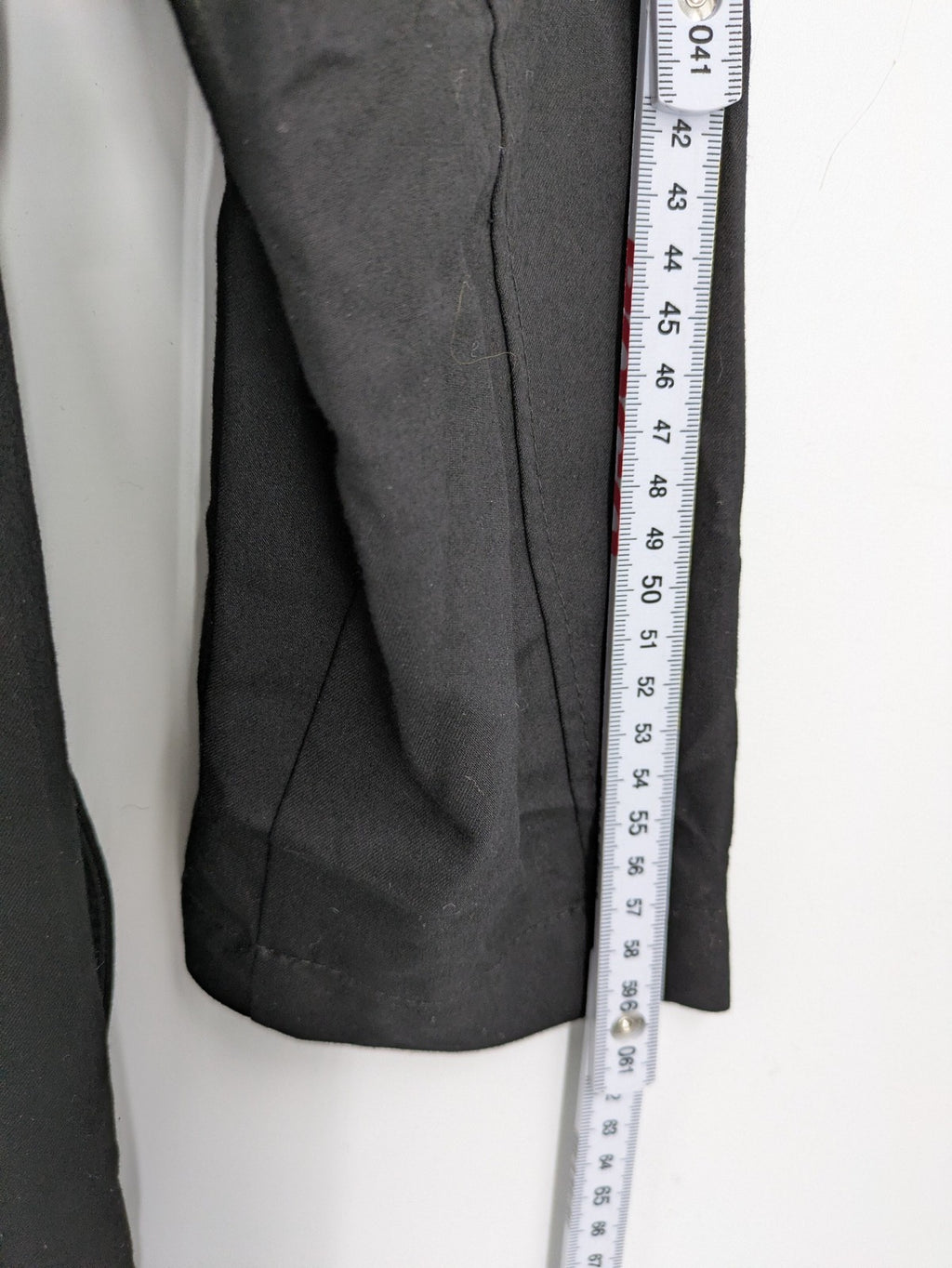 Alvina black trench coat with lace collar and gold buttons, belted waist design.