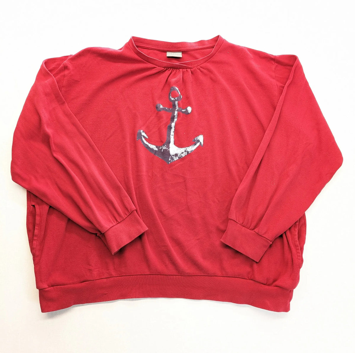 Normann red turtle neck jumper with large anchor print and side pockets.