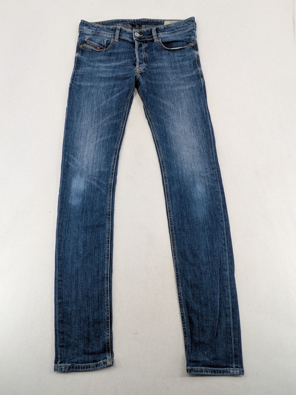 Diesel blue slim skinny jeans with logo patch and stretch denim material.