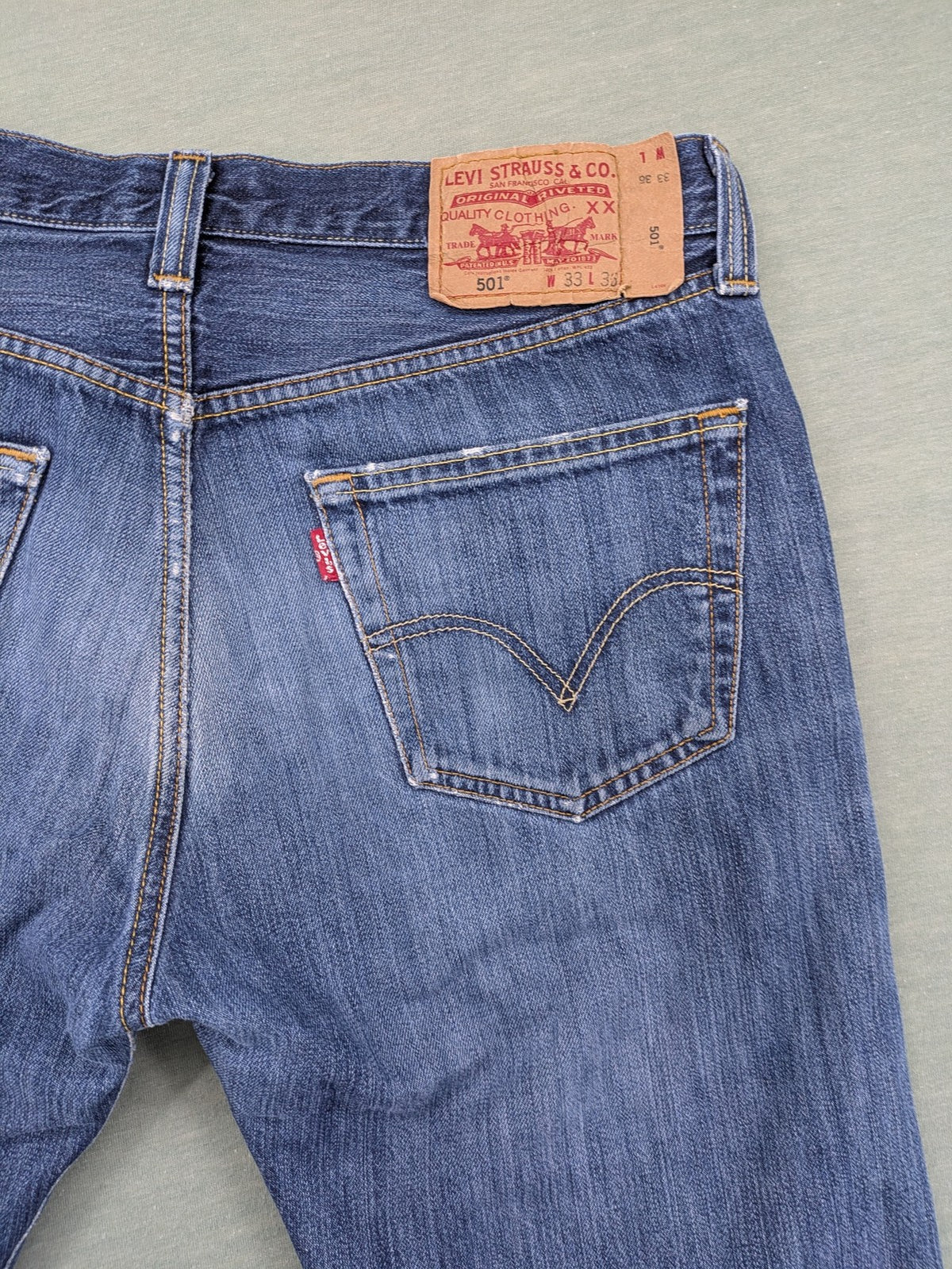 Levi's blue cut-off shorts with frayed hem, classic 5-pocket design, button fly.