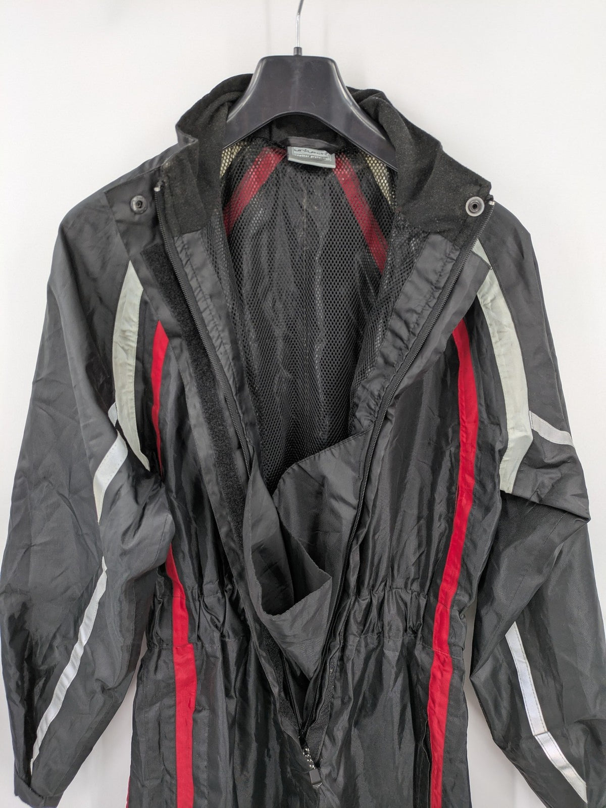 Unitech black rain suit with red reflective stripes and full zipper, size M.