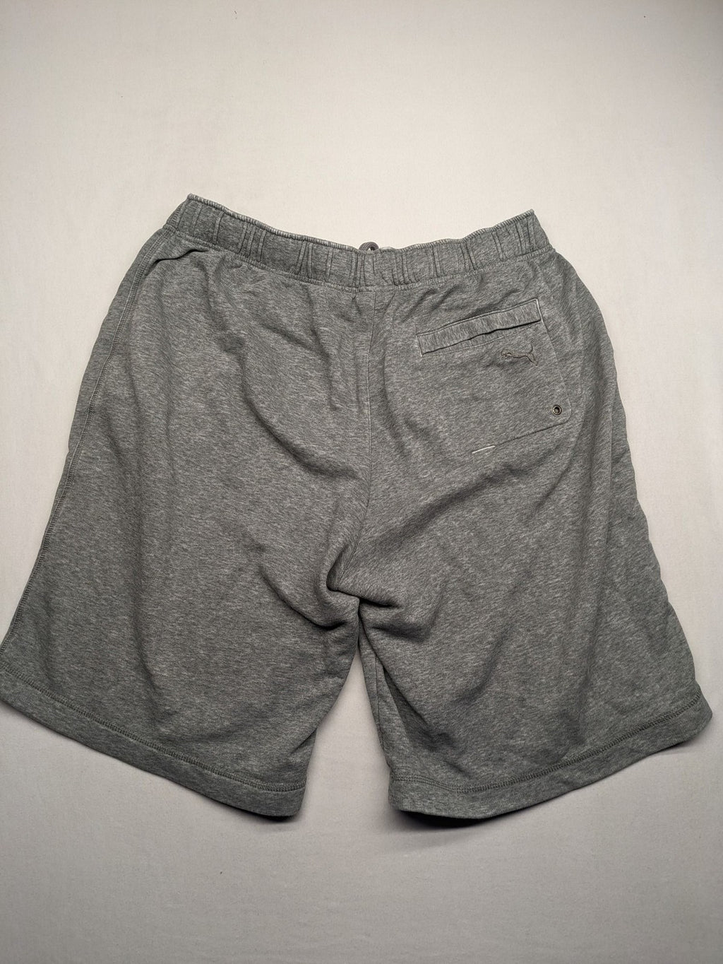 Puma grey sweat shorts with embroidered logo, made from cotton-polyester blend.