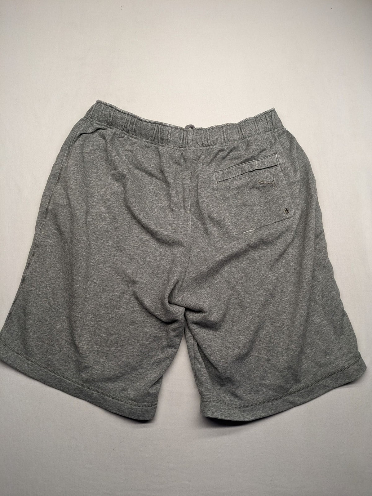 Puma grey sweat shorts with embroidered logo, made from cotton-polyester blend.