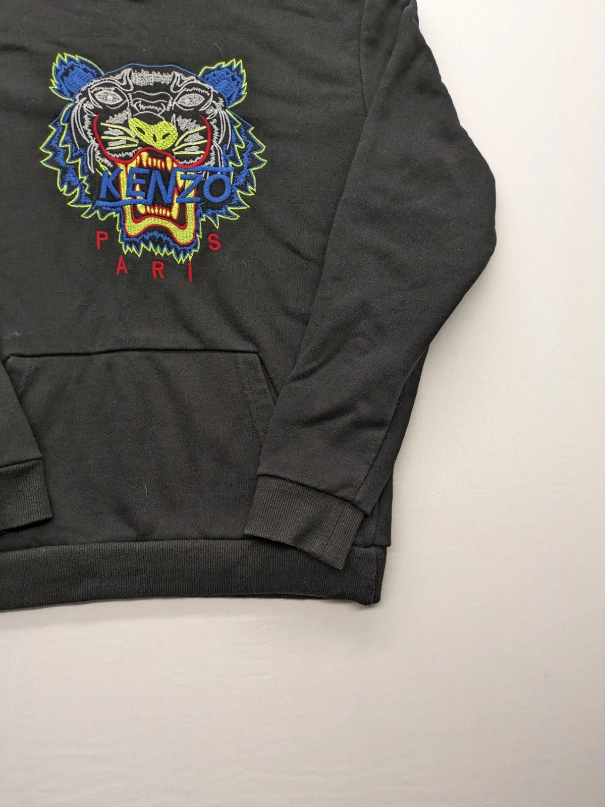 Kenzo multi hoodie with embroidered tiger graphic, drawstring hood, and kangaroo pocket.