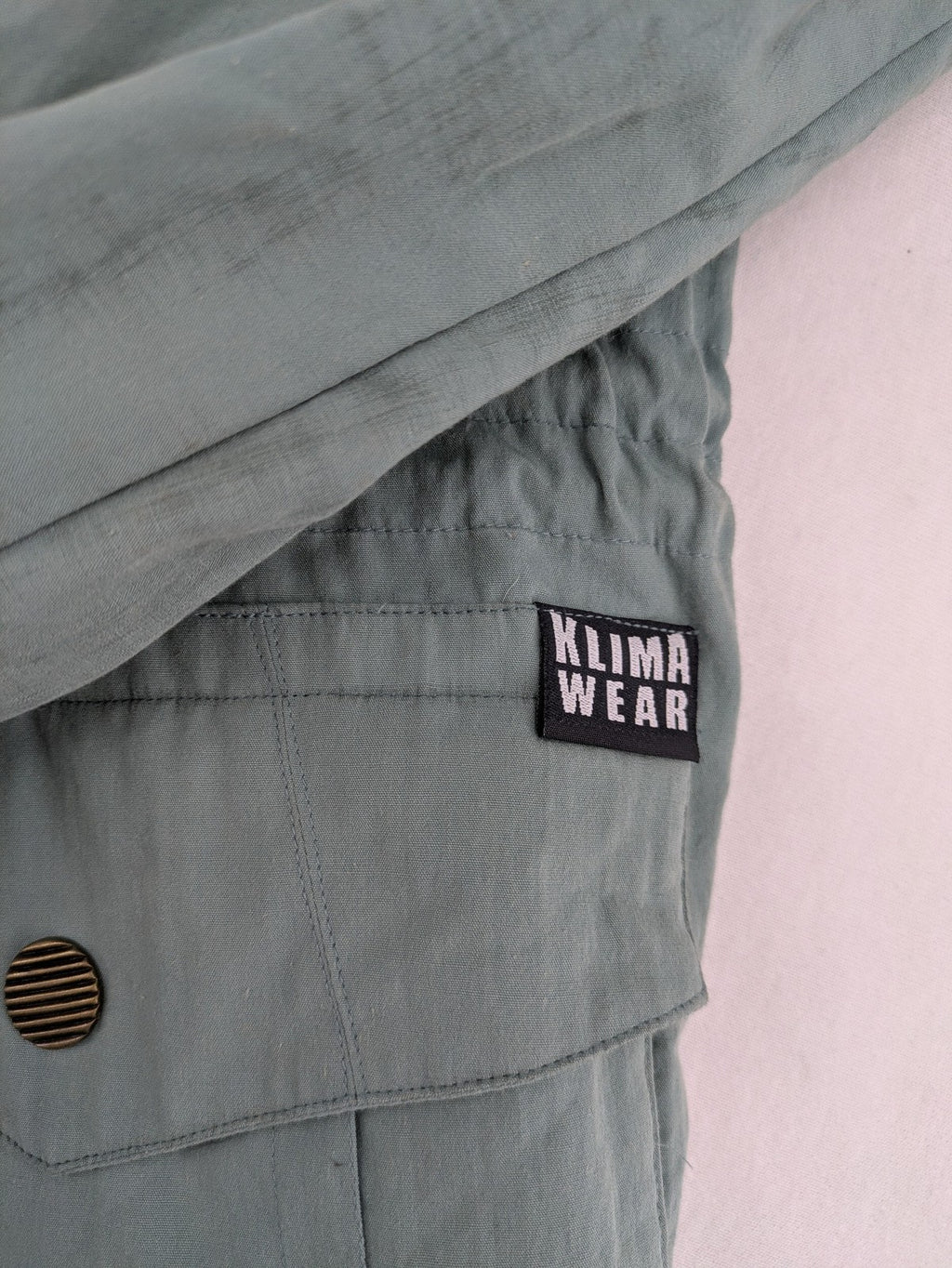 Klima green jacket vintage style, windproof, waterproof, with hidden hood and multiple pockets.