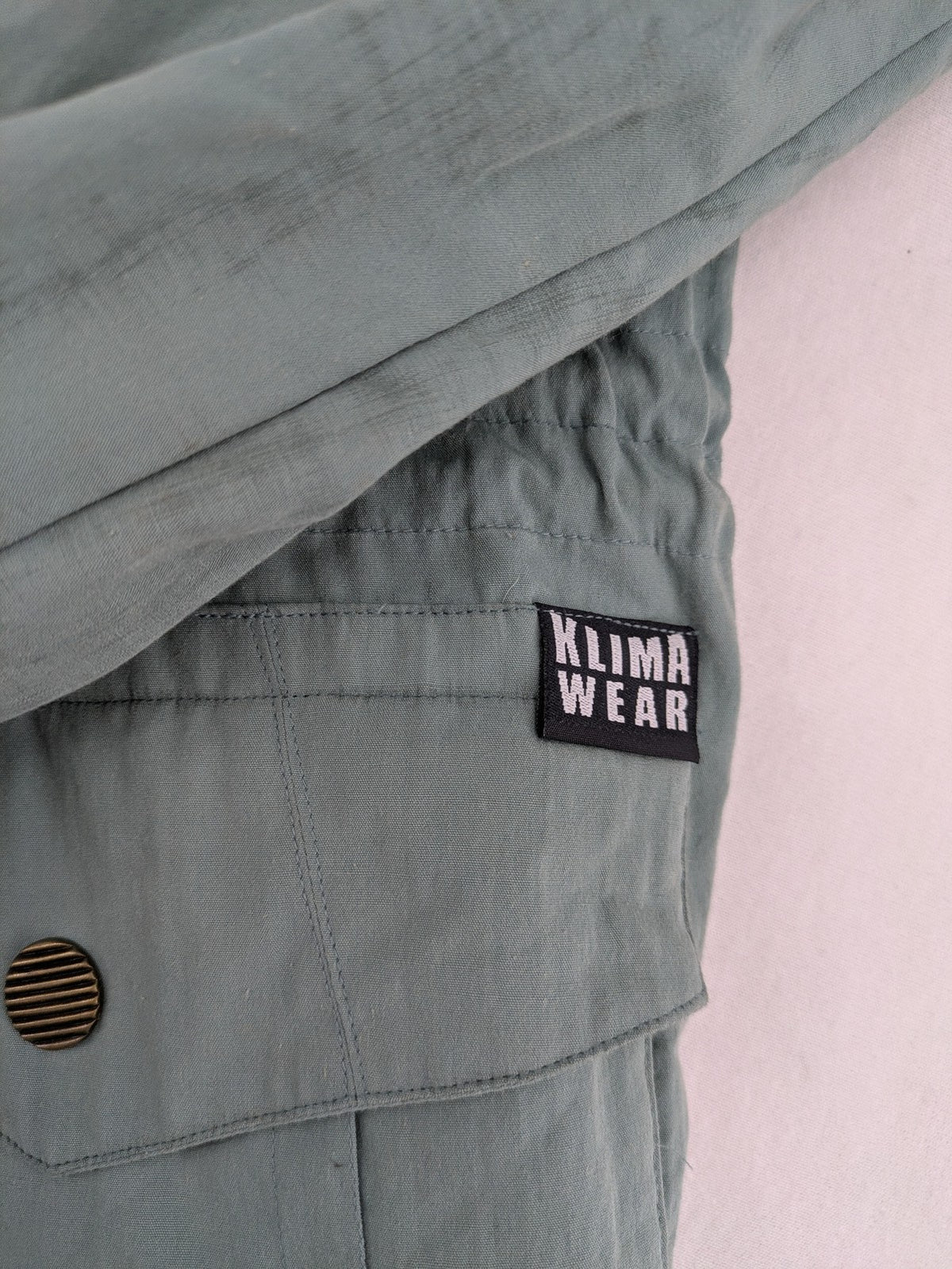 Klima green jacket vintage style, windproof, waterproof, with hidden hood and multiple pockets.