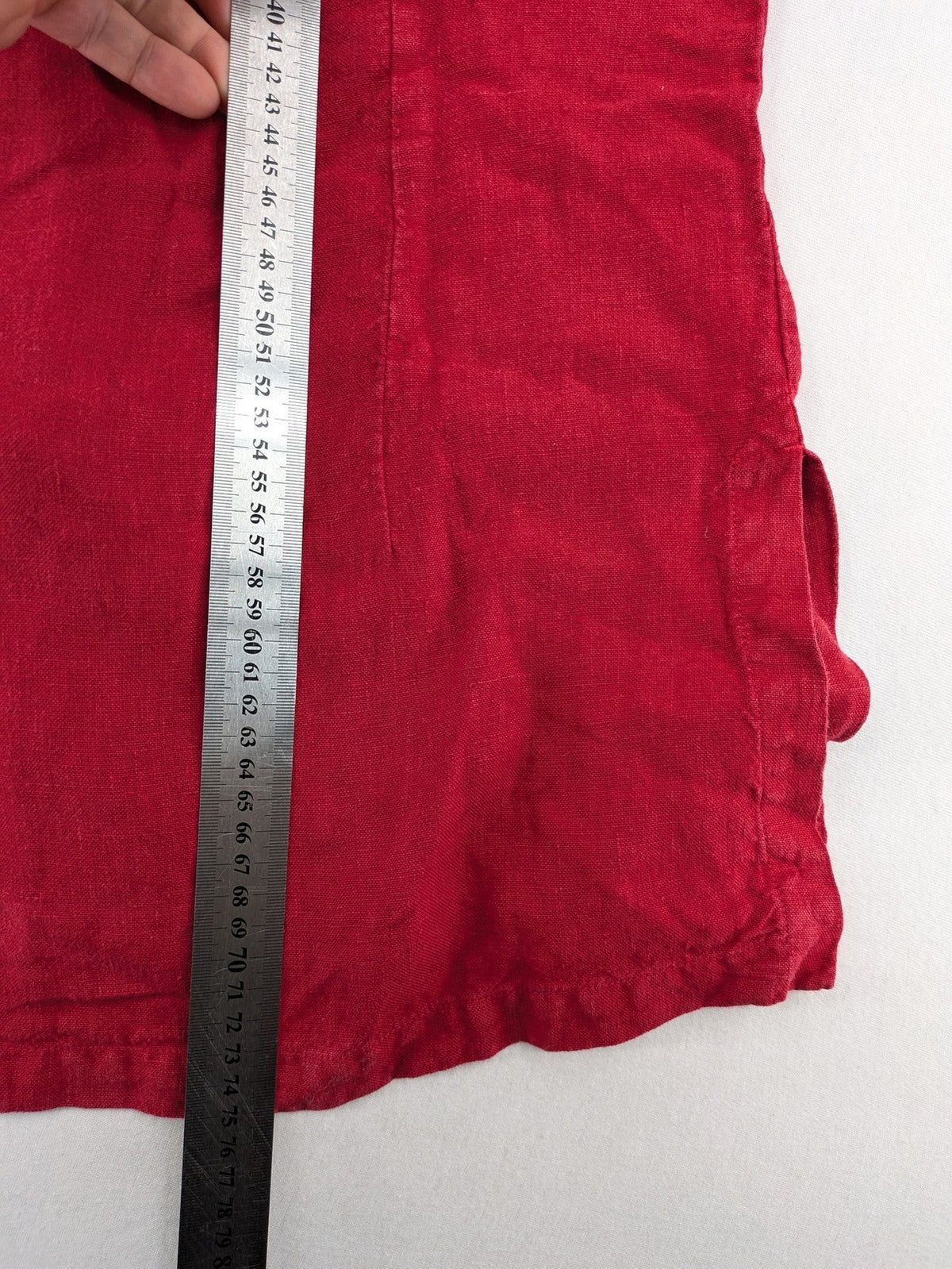 Deerberg red short-sleeve linen blouse with collar, button placket, and side slits.
