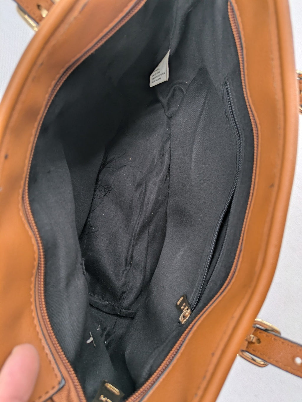 L&H brown and black handbag with monogram pattern and gold accents, versatile shoulder strap.