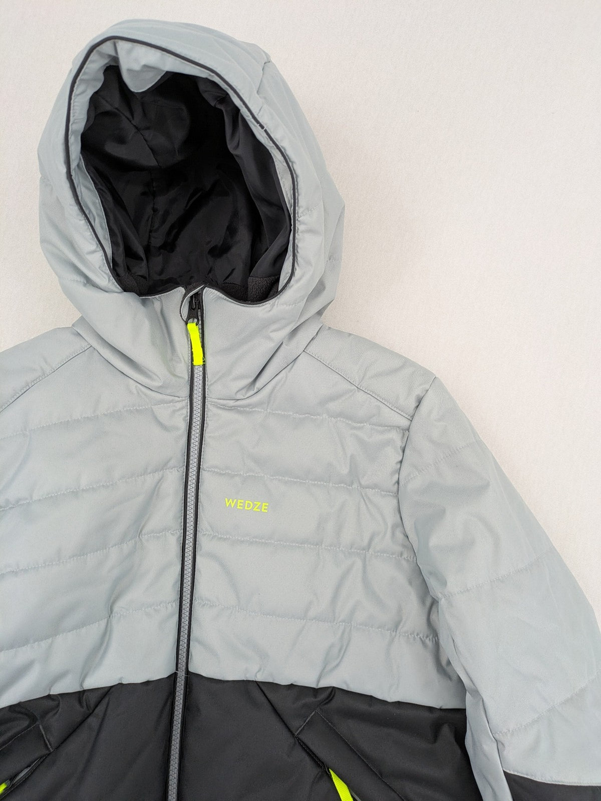 Wedze ski coat grey and black colorblock design with neon accents and fleece lining.