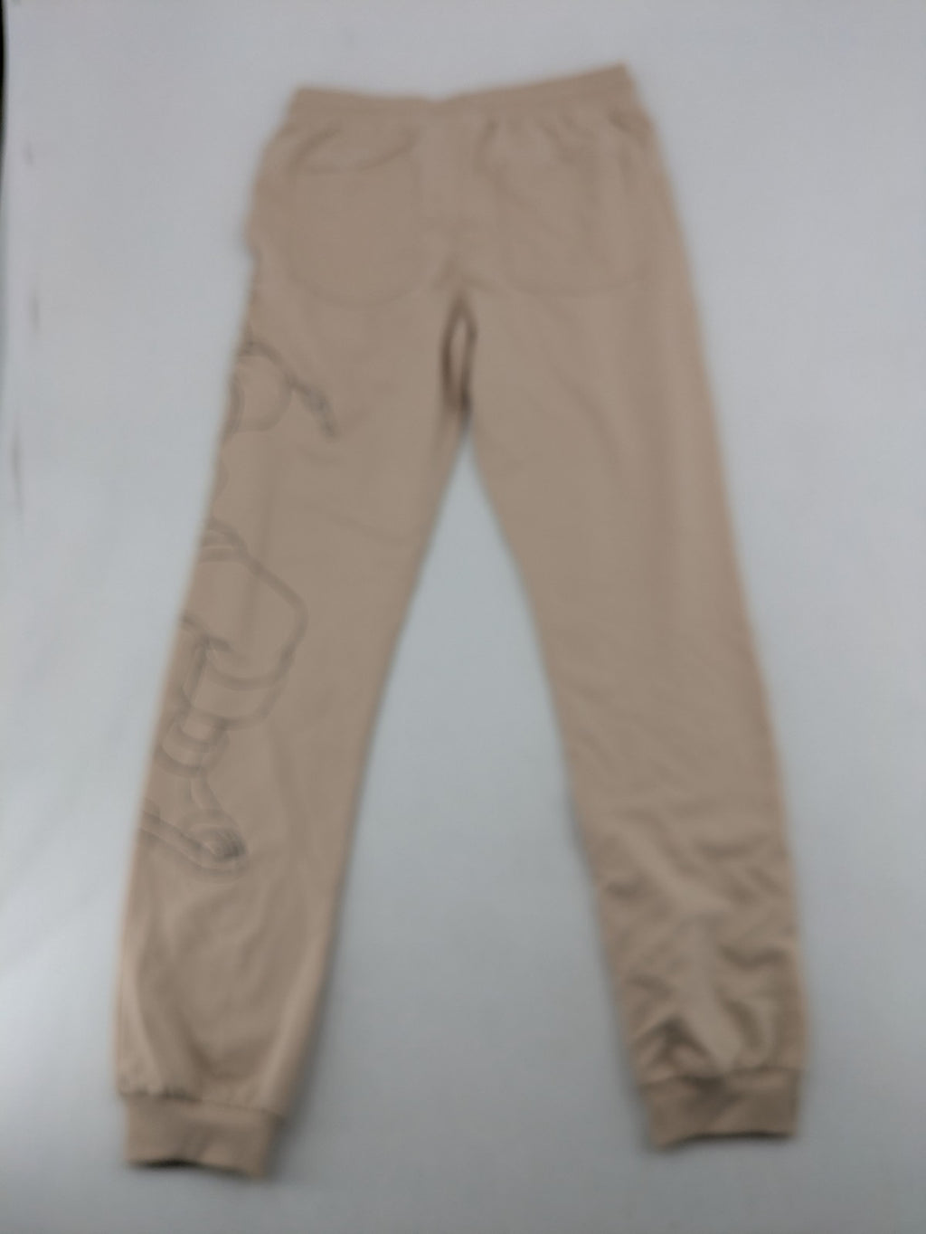 Naruto Shippuden beige joggers featuring Naruto Uzumaki graphic and logo print.