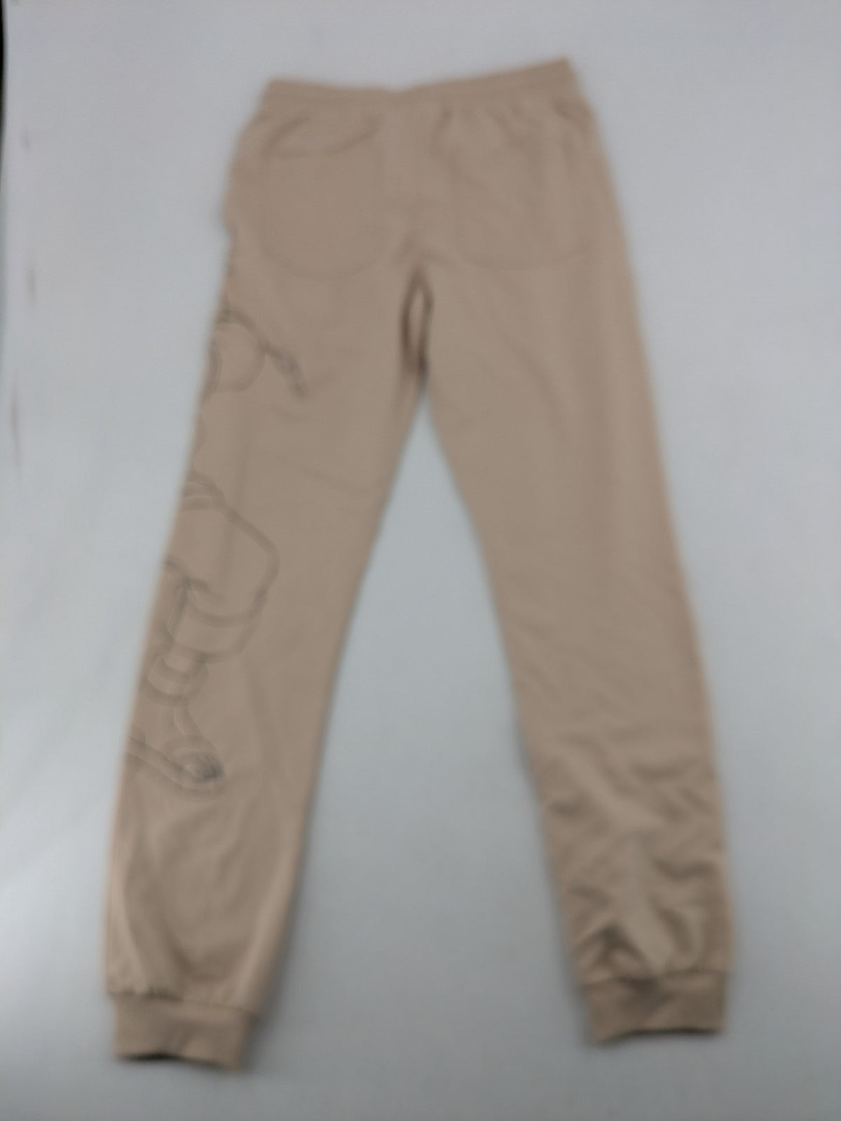 Naruto Shippuden beige joggers featuring Naruto Uzumaki graphic and logo print.