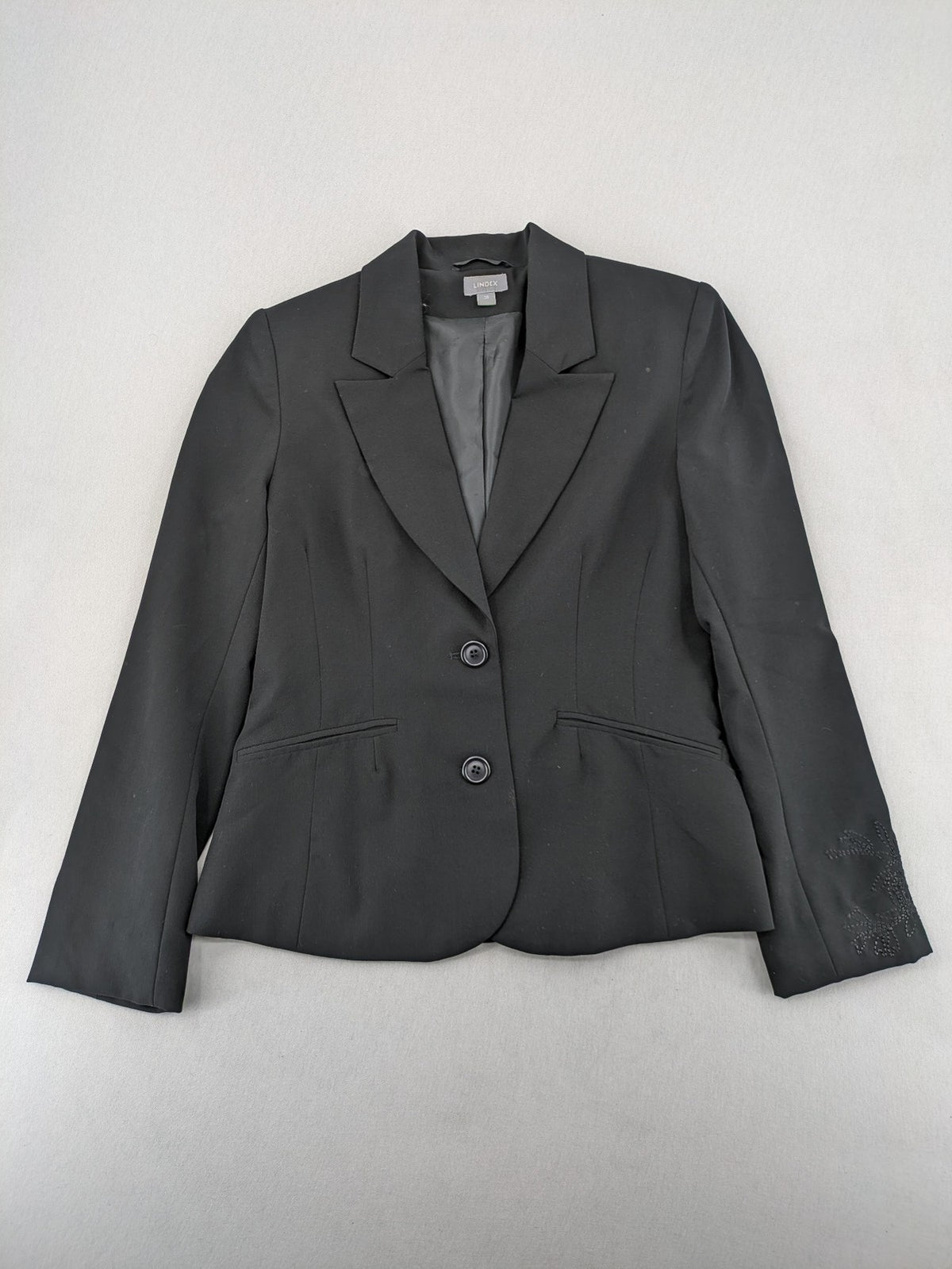 Lindex black blazer coat two-button design with subtle embroidery and tailored silhouette.