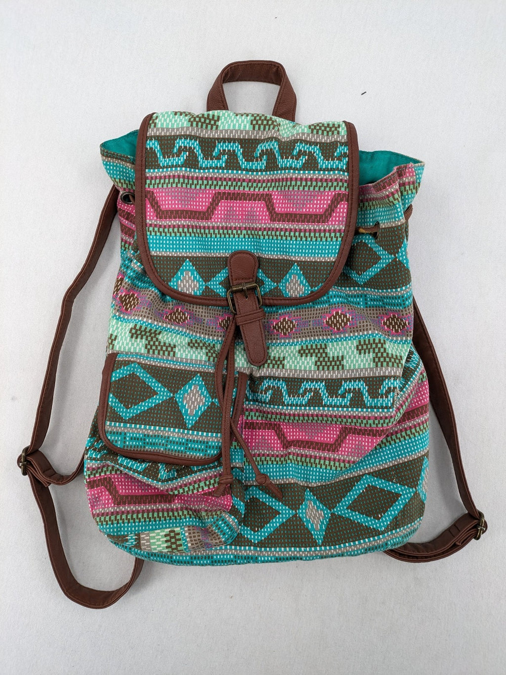 Boho multi backpack with vibrant Aztec tribal print and brown faux leather accents.
