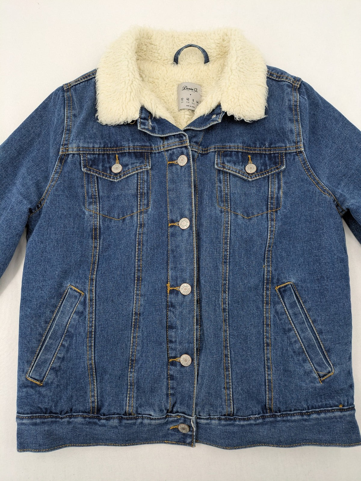 Denim & Co. blue jacket with cream Sherpa lining, button closure, and pockets.
