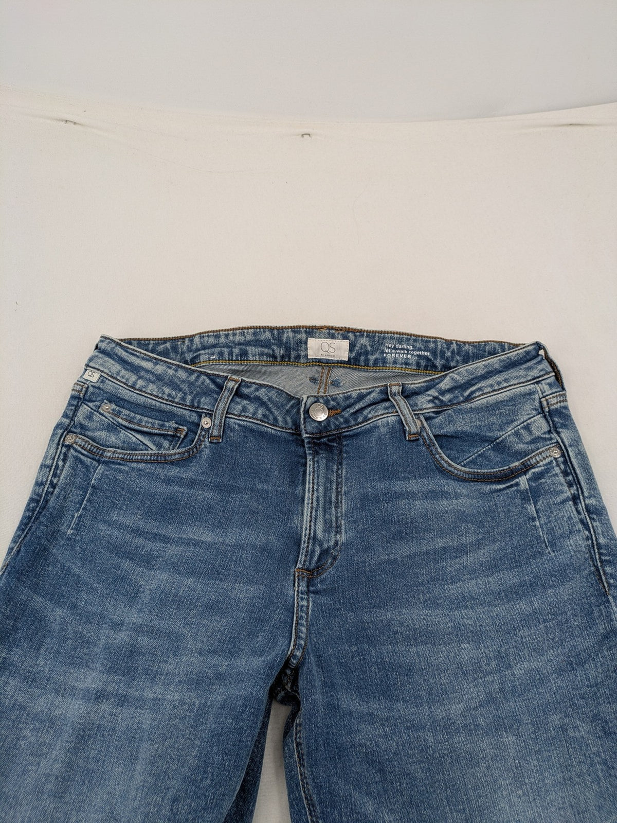 QS by s.Oliver green bootcut jeans with ankle zippers and classic denim wash.