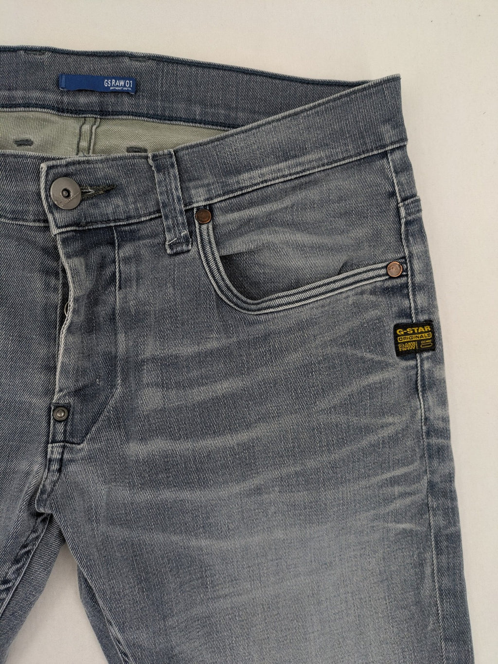 G-Star Raw grey denim straight jeans with classic button fly and subtle branding details.