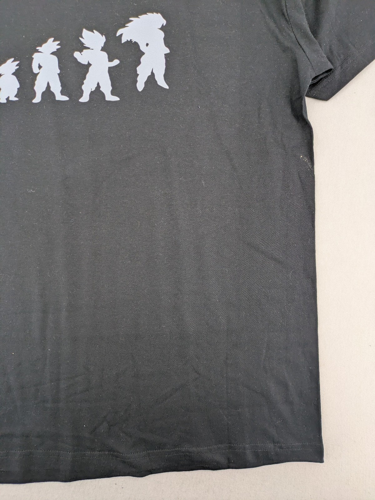 Dragon Ball Z blue and grey t-shirt featuring Son Goku evolution graphic, 100% cotton.