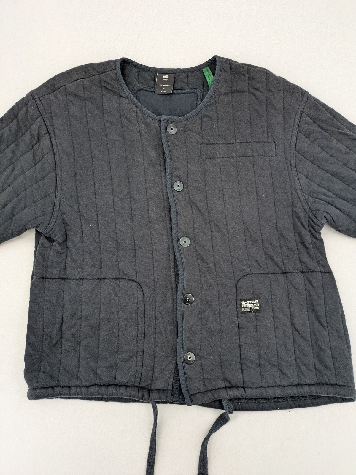 G-Star Raw grey quilted jacket with button closure and adjustable drawstring hem.