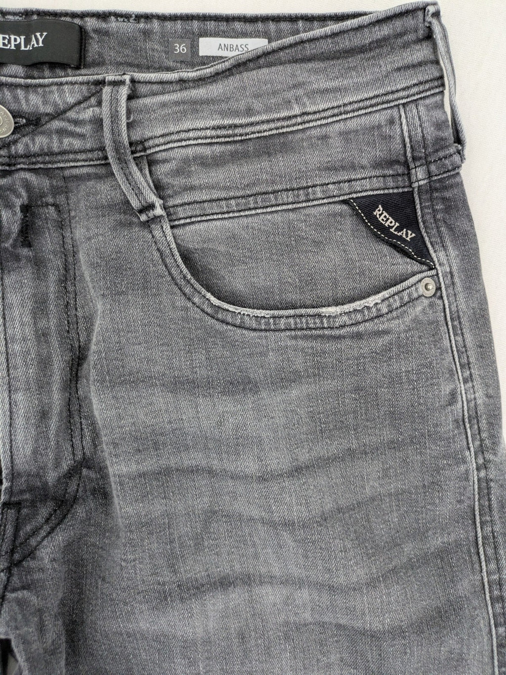 Replay grey straight jeans faded wash five-pocket style with logo on pocket.