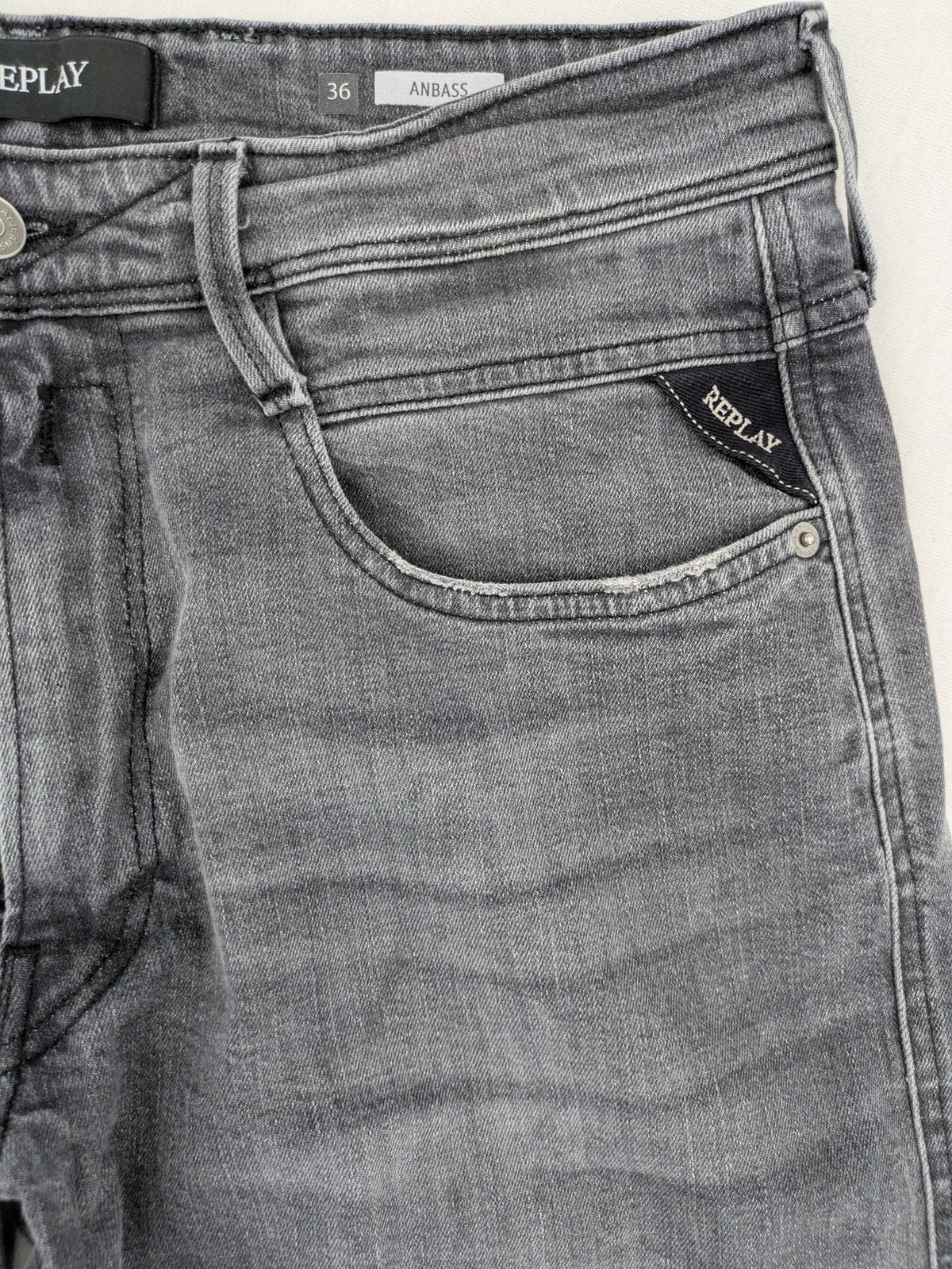 Replay grey straight jeans faded wash five-pocket style with logo on pocket.