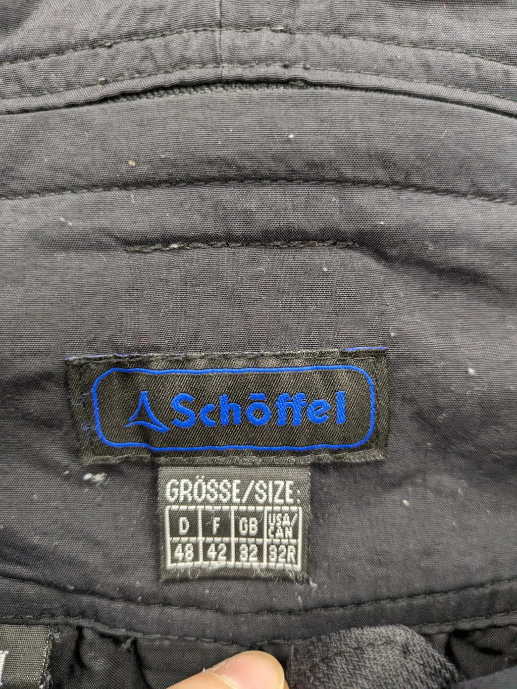 Schoffel black ski pants with adjustable straps, zip pockets, and snow gaiters.