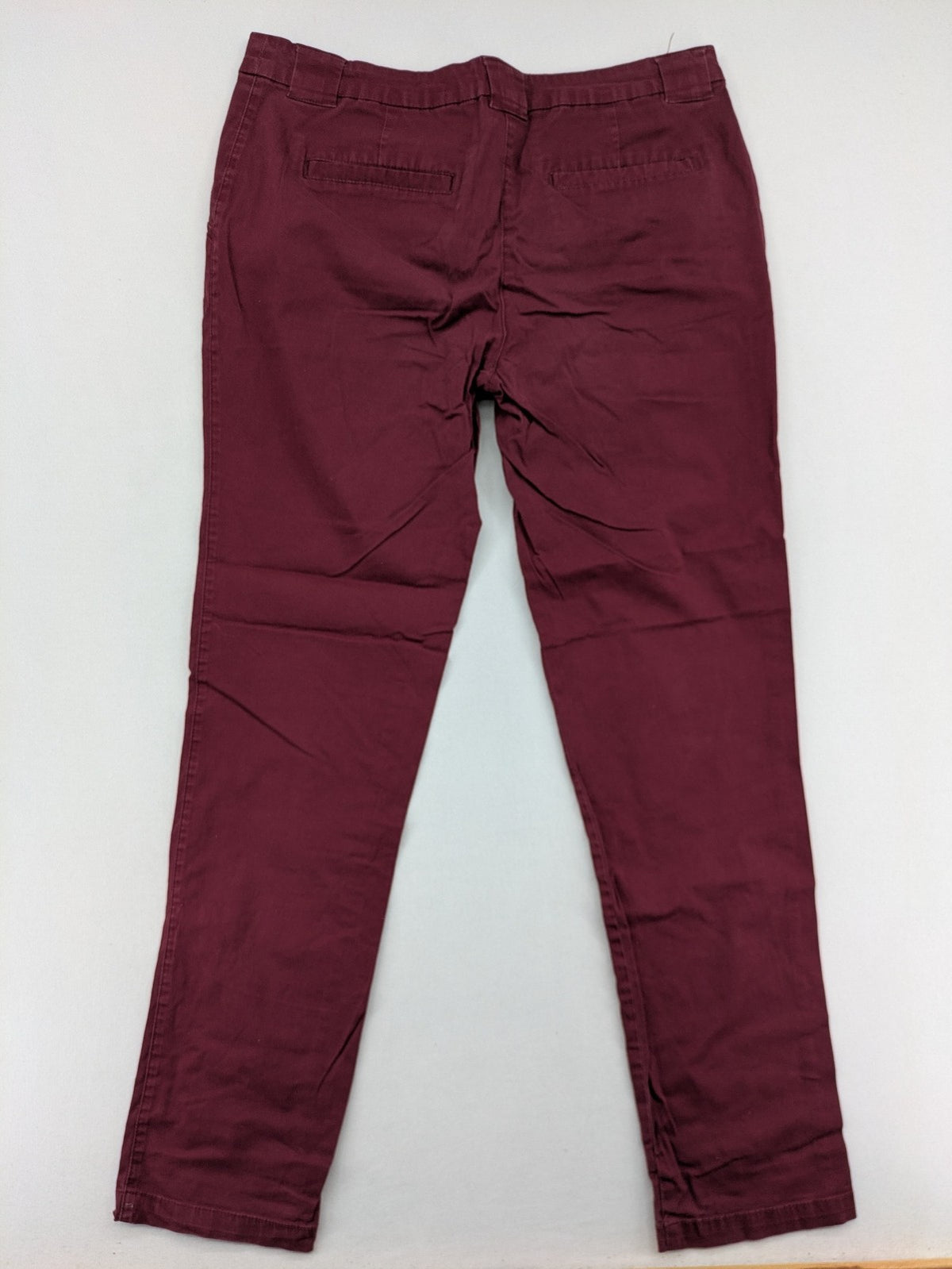 BPC Bonprix burgundy chino pants with front pleats and floral pocket lining.