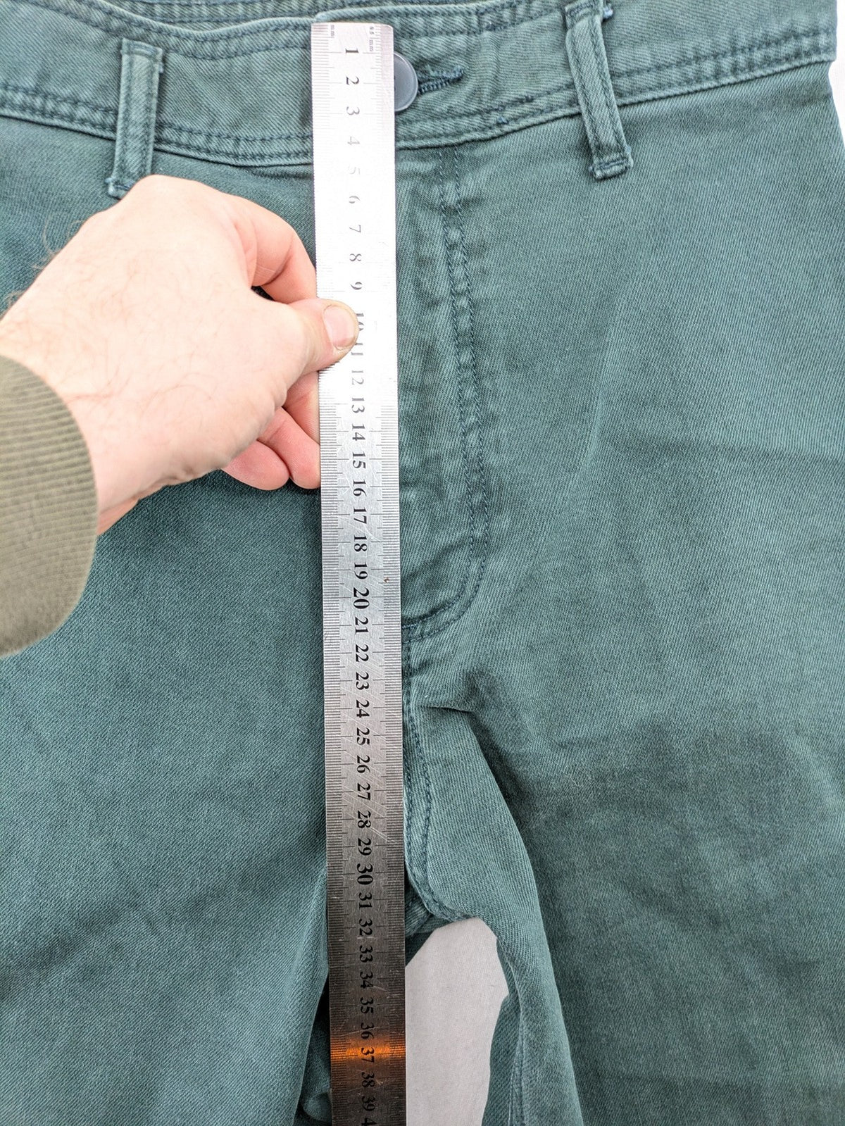 Zara green high waist wide leg jeans with frayed hem and button closure.
