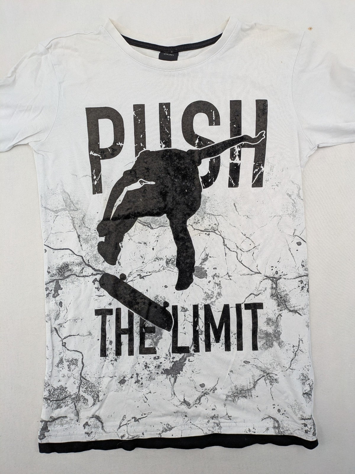 Chapter Young long sleeve shirt white with black skateboarder graphic and motivational text.
