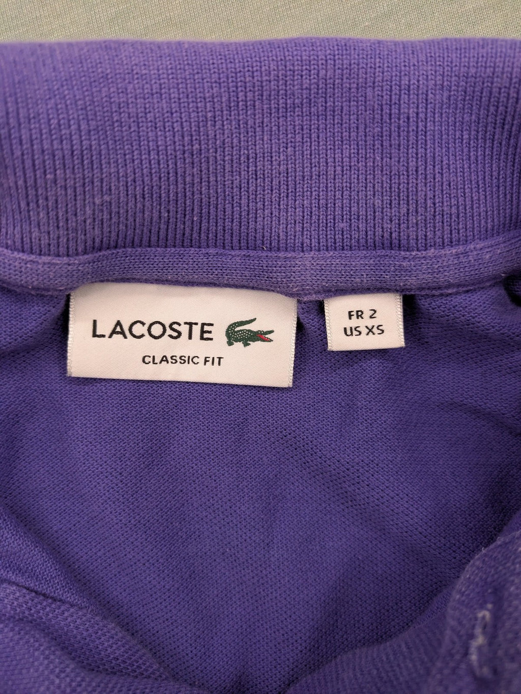 Lacoste purple polo shirt classic fit with embroidered crocodile logo and short sleeves.