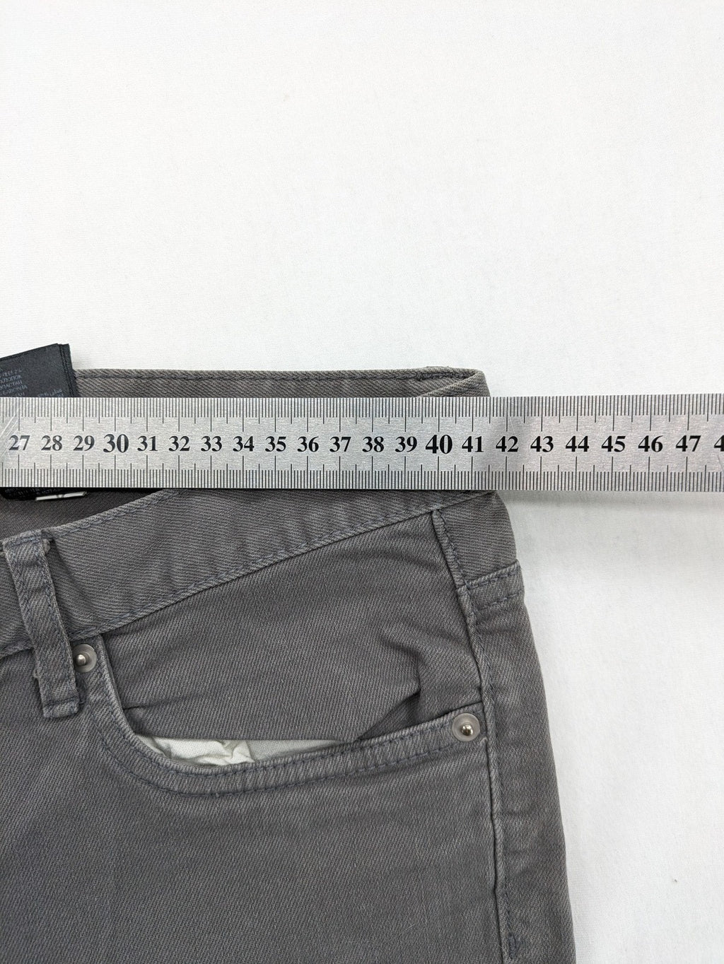 H&M grey skinny fit jeans with button closure and five-pocket design, cotton-elastane blend.