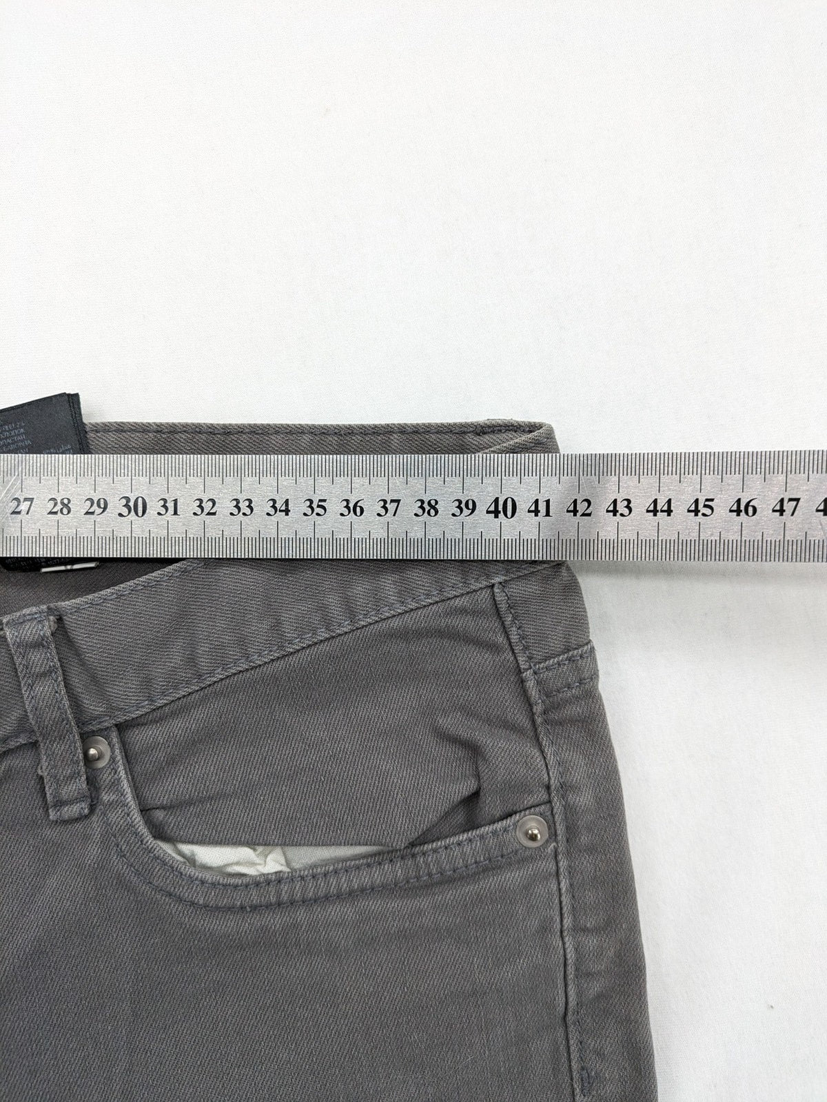 H&M grey skinny fit jeans with button closure and five-pocket design, cotton-elastane blend.