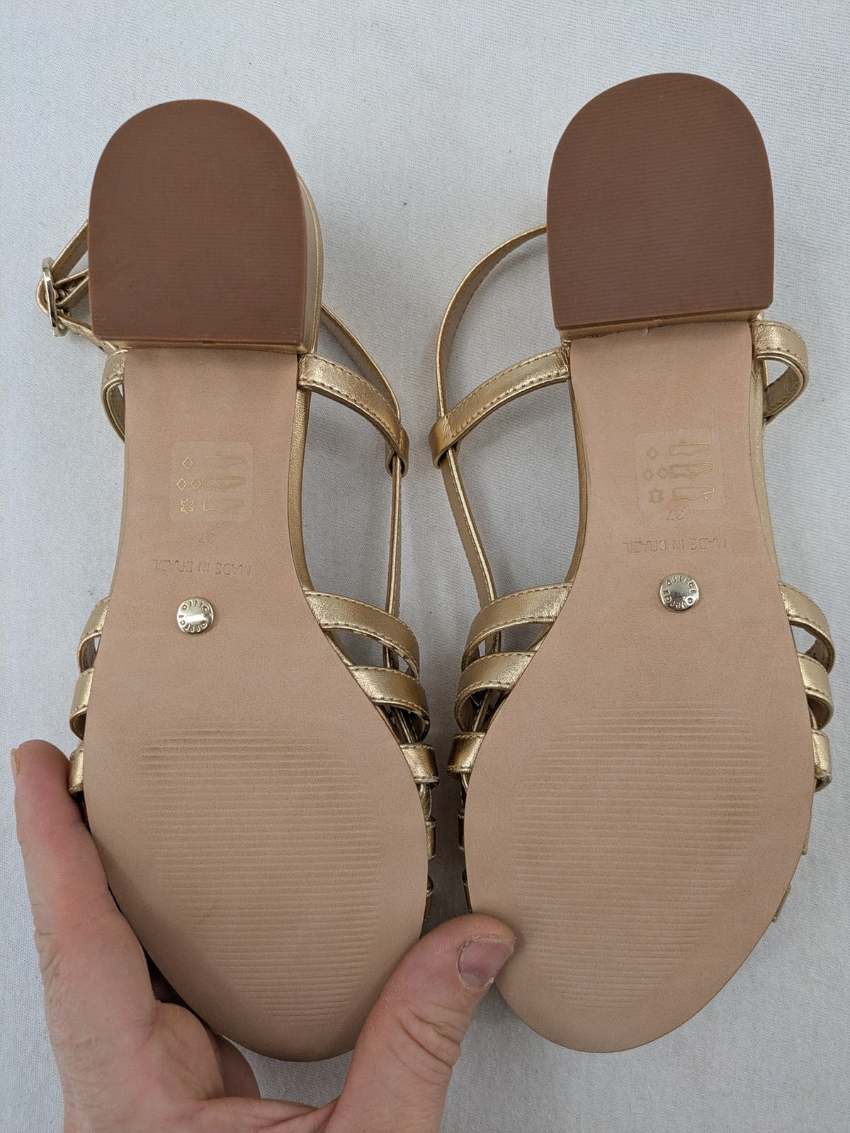 Office London gold metallic sandals with adjustable ankle strap and block heel design.