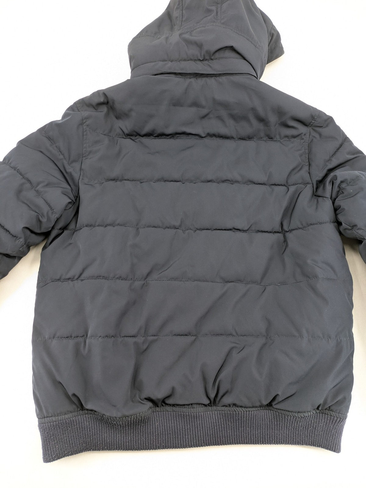 Tom Tailor navy puffer jacket with quilted design and adjustable hood, featuring multiple pockets.