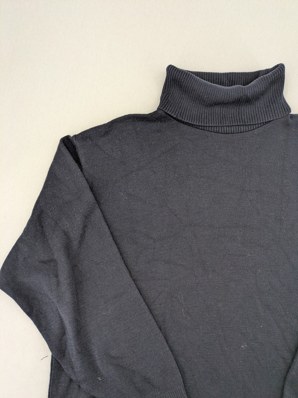 Dinovo grey knit jumper with ribbed roll neck and cuffs, made from merino wool blend.