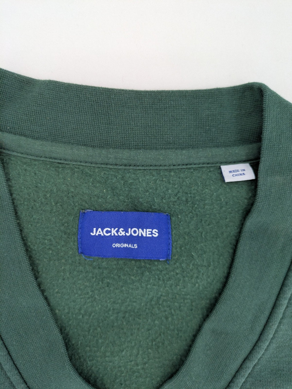 Jack & Jones Originals green vest with embroidered Athletic Club 1990 logo and V-neck.