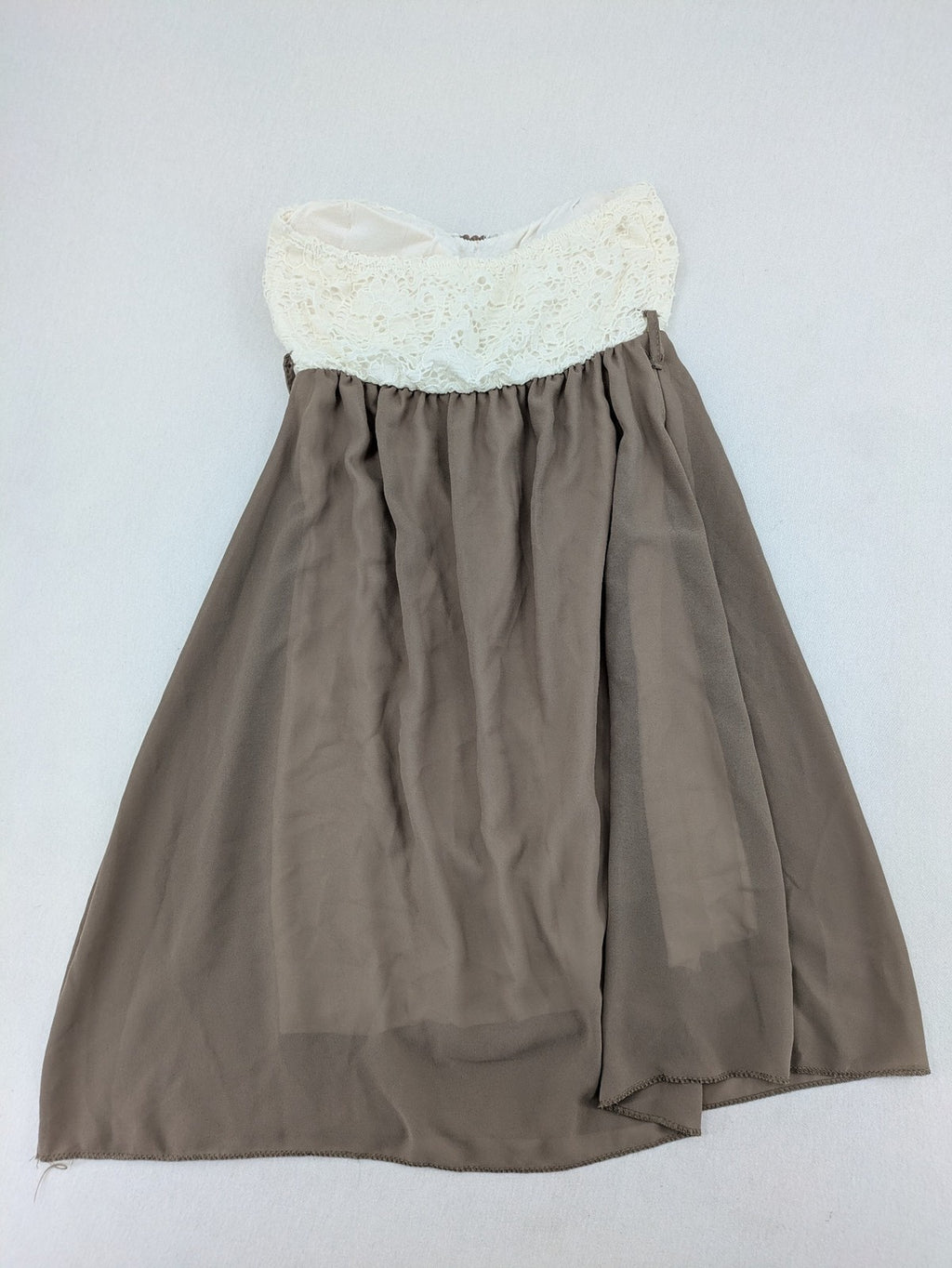 Creme bandeau summer dress in taupe with lace top and decorative gold buttons.