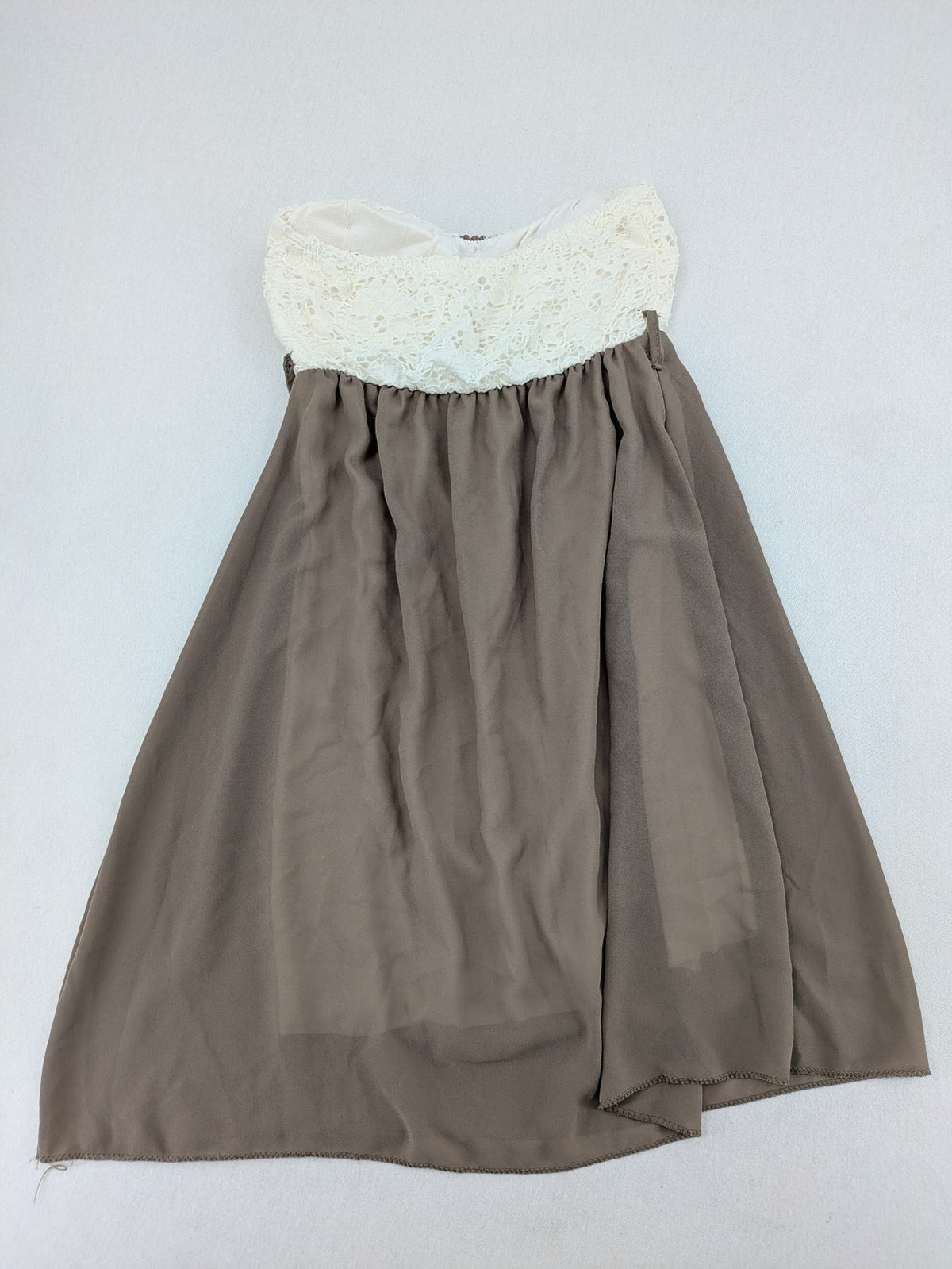 Creme bandeau summer dress in taupe with lace top and decorative gold buttons.