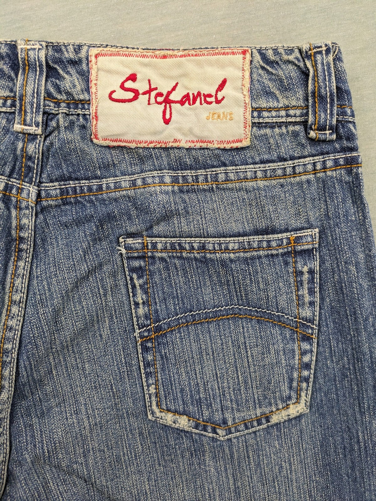 Stefanel blue straight jeans with cuffed hem and classic 5-pocket design.