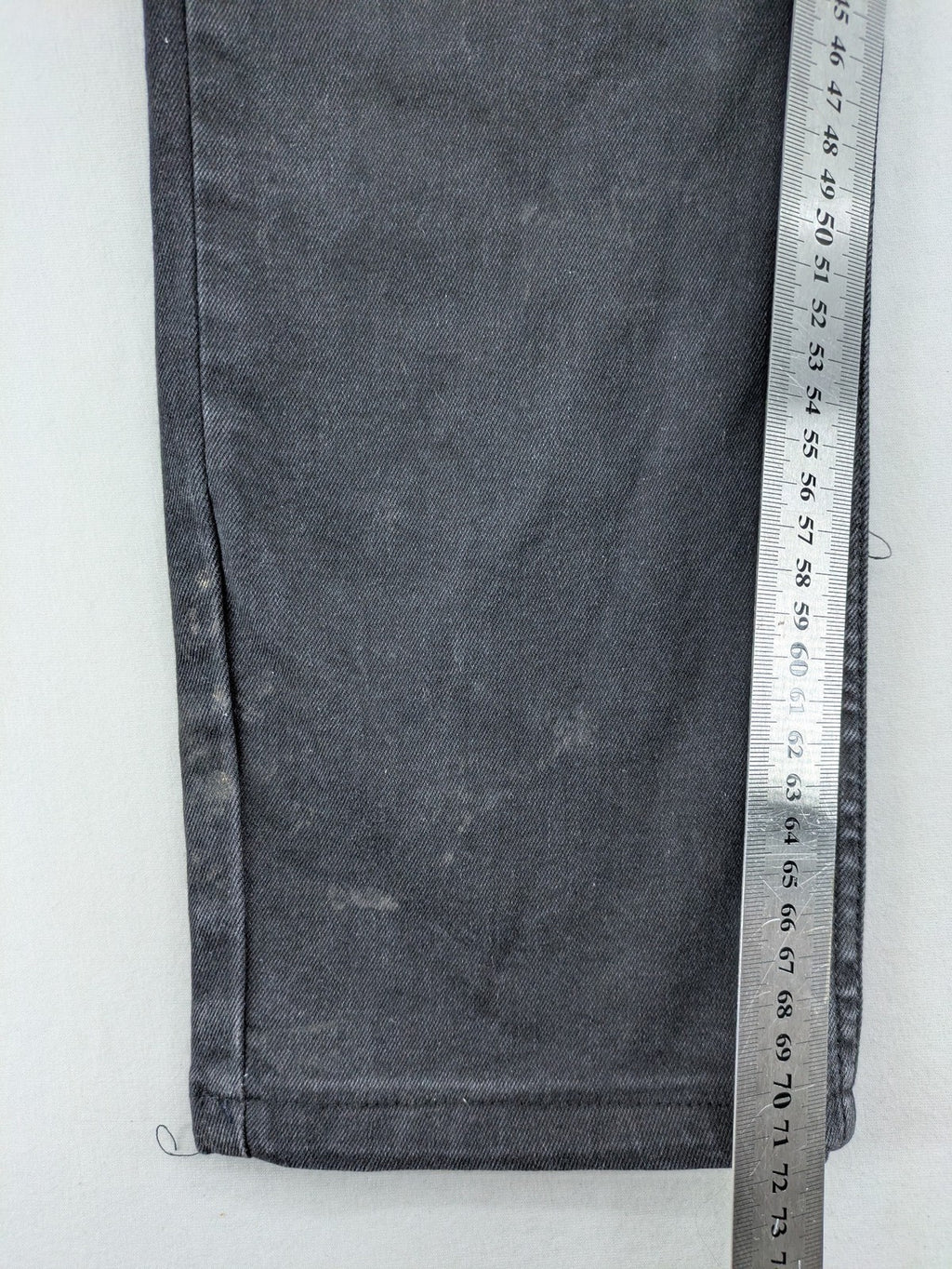 Philipp Plein black straight jeans with distressed finish and skull patch detail.